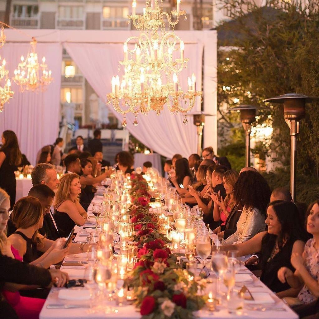 Chandeliers, candlelight and deep red roses create a romantic scene for this <a href="/shuttersca/">Shutters on Beach</a> wedding | Photo: @kathleengeiberger | Venue: <a href="/Shut/">Victor Castillo H.</a>…