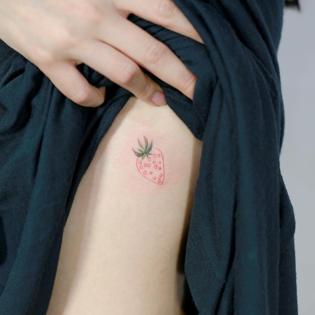 Hand poked strawberry tattoo done with red ink located #6 Hand poked strawberry tattoo done with red ink located