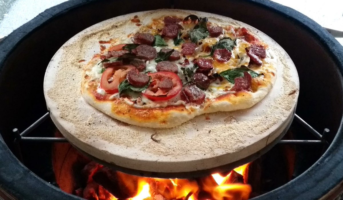 Enjoy the wood fired flavor of pizza baked in your own backyard! No gas, gadgets, or electricity required! #smoker #kamado