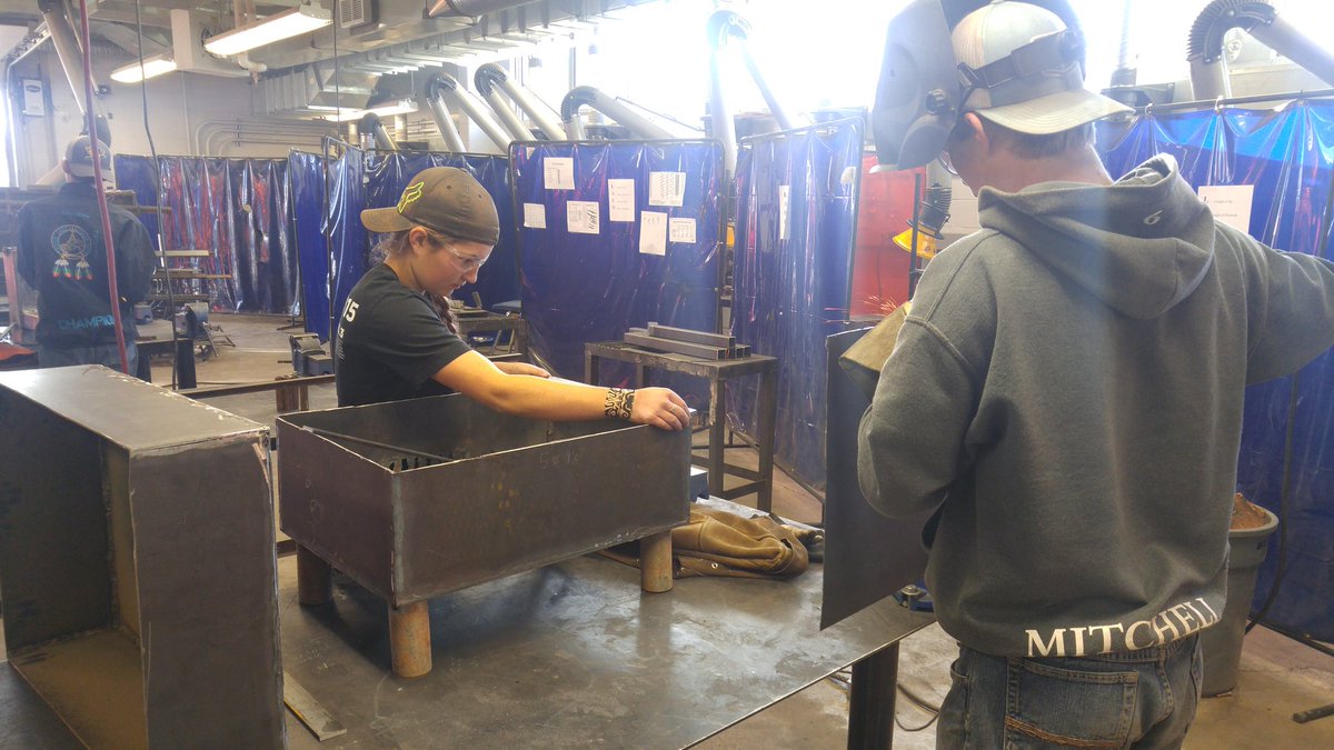 Final touches are being done on custom bbques in preparation for today's hot dog roast.