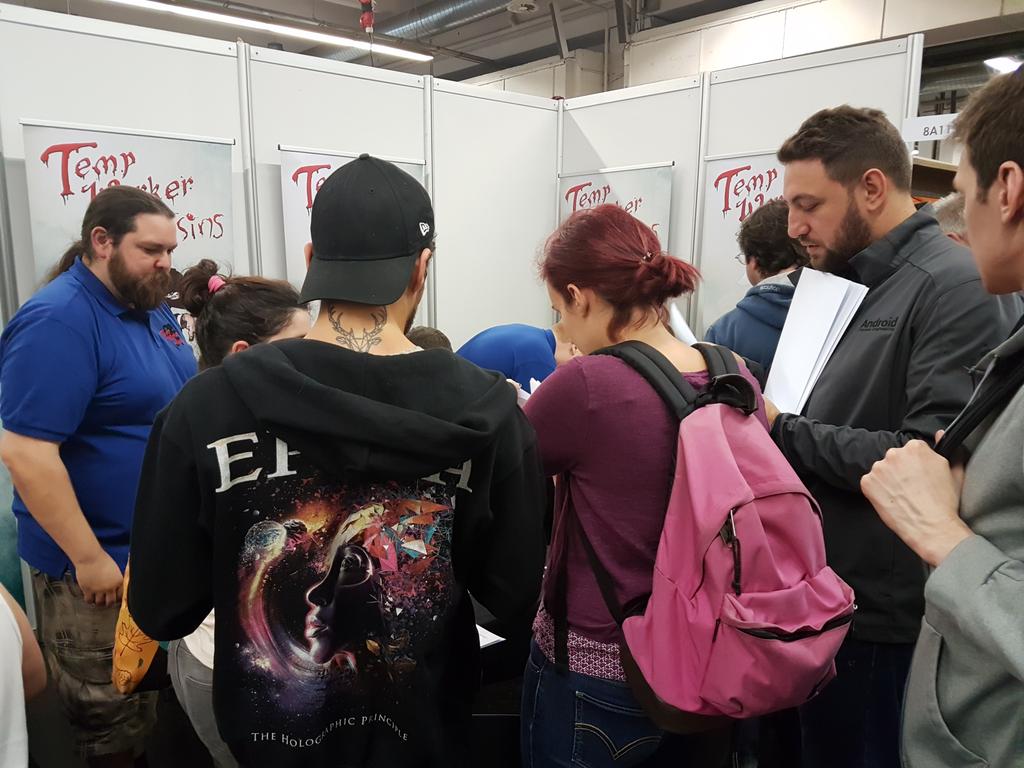 Everyone flicking through the free art prints they get when buying the game. Don't miss out! #Essen17 #Spiel17