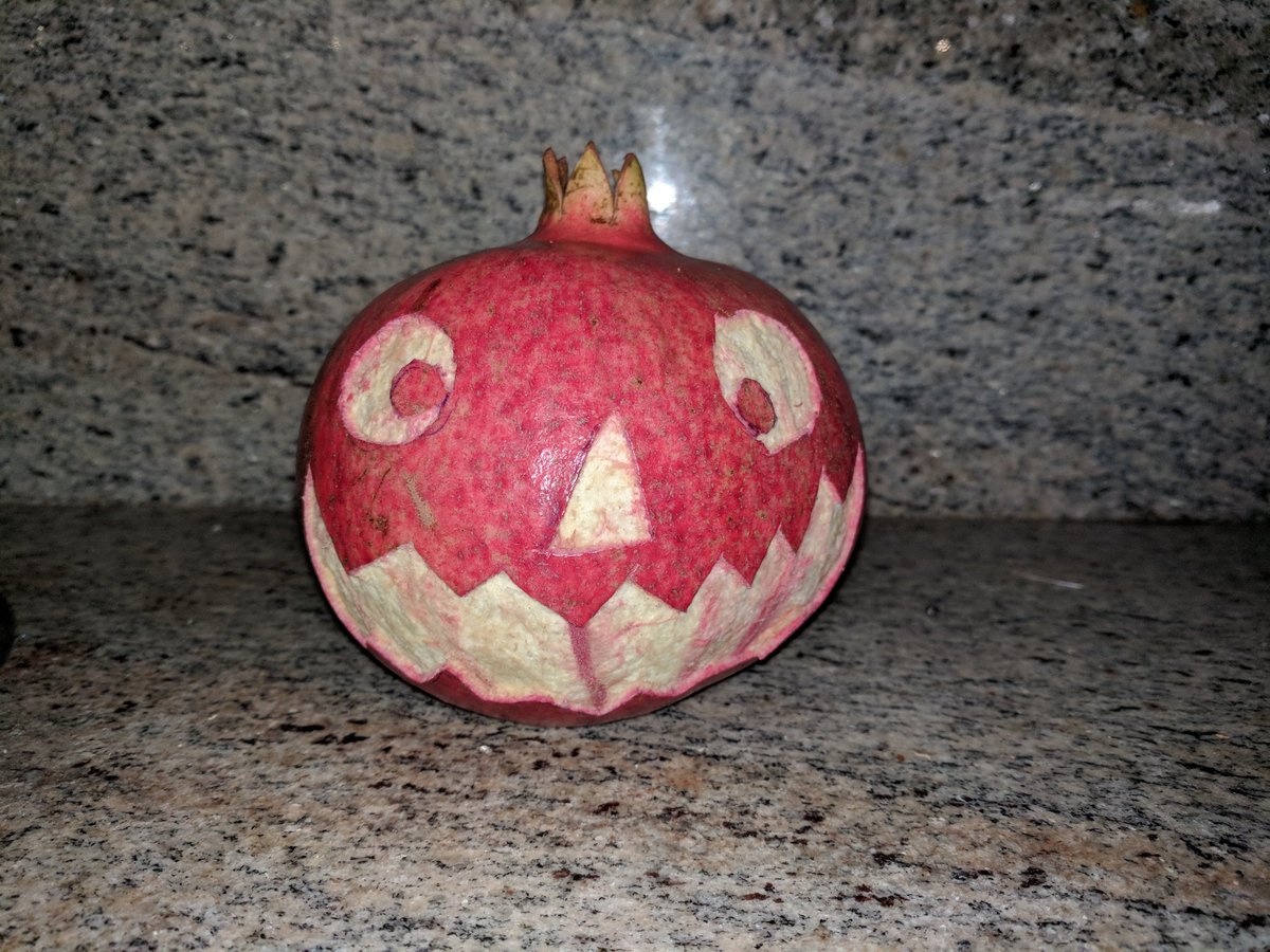 MachineEmpath's tweet image. Homegrown pomegranate jack-o&apos;-lantern treat for the neighbors.  Our response to being #BOOed.