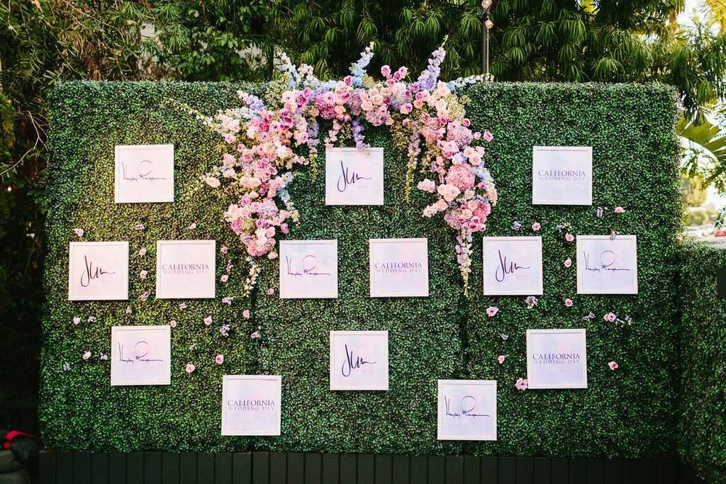 Create a dynamic backdrop and step-and-repeat by adding a few florals to our green hedges. || Venue: <a href="/jlmboutique/">JLM Boutique</a> | Gowns: <a href="/misshayleypaige/">Hayley Paige</a>…