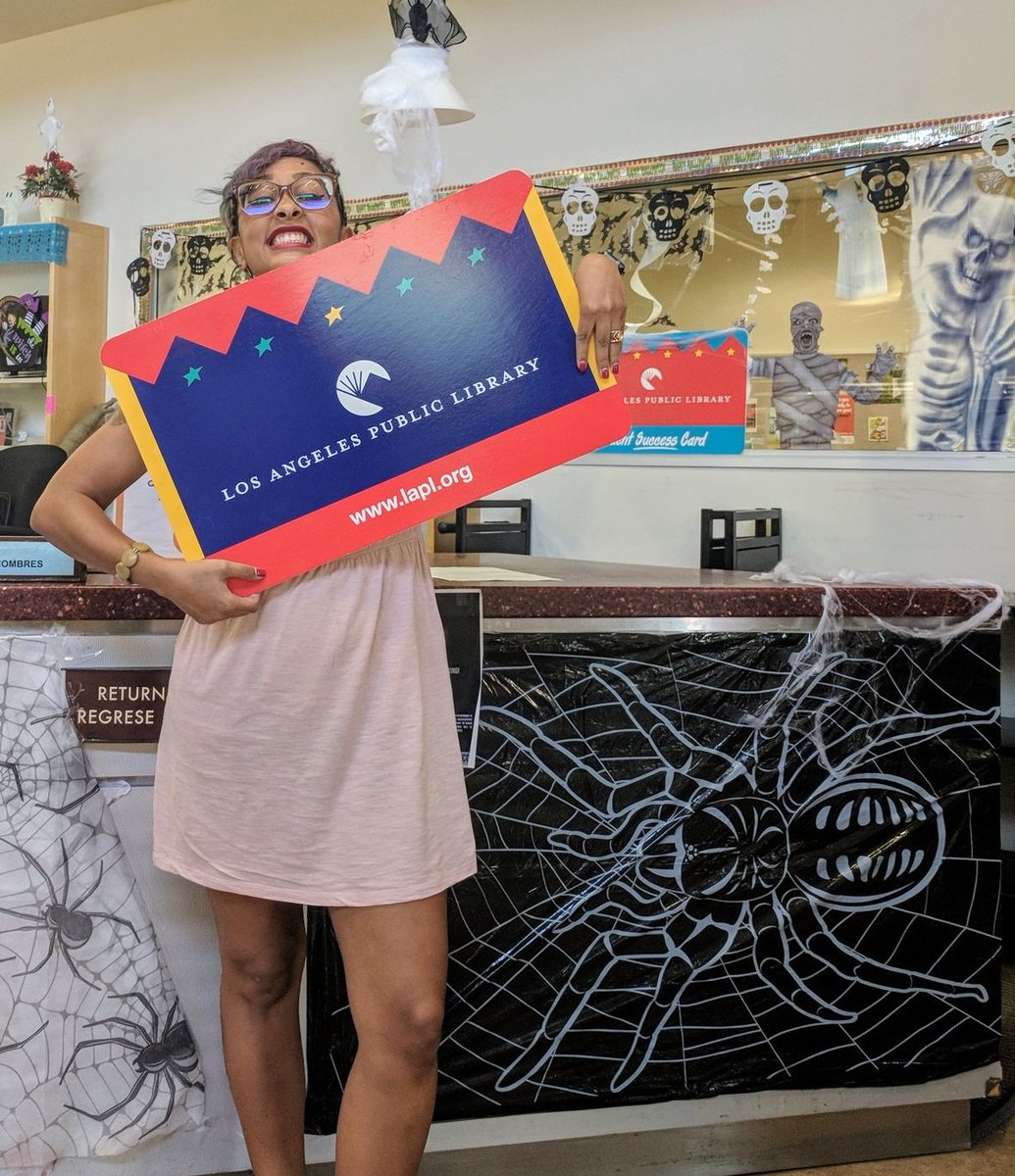 Eve Ewing holding library card