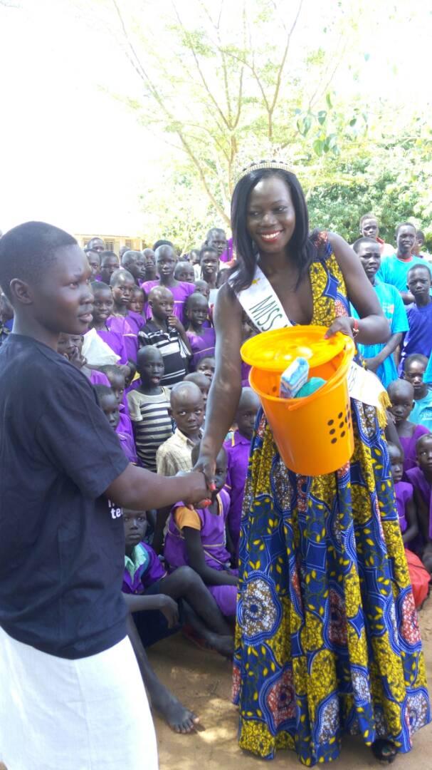 UNFPAUganda's tweet photo. Here's #MissMadi handing over #hygiene kits to #young girls in #Boroli refugee settlement. Her message: "Keep in school & live your dream". https://t.co/w0GjokP5h5