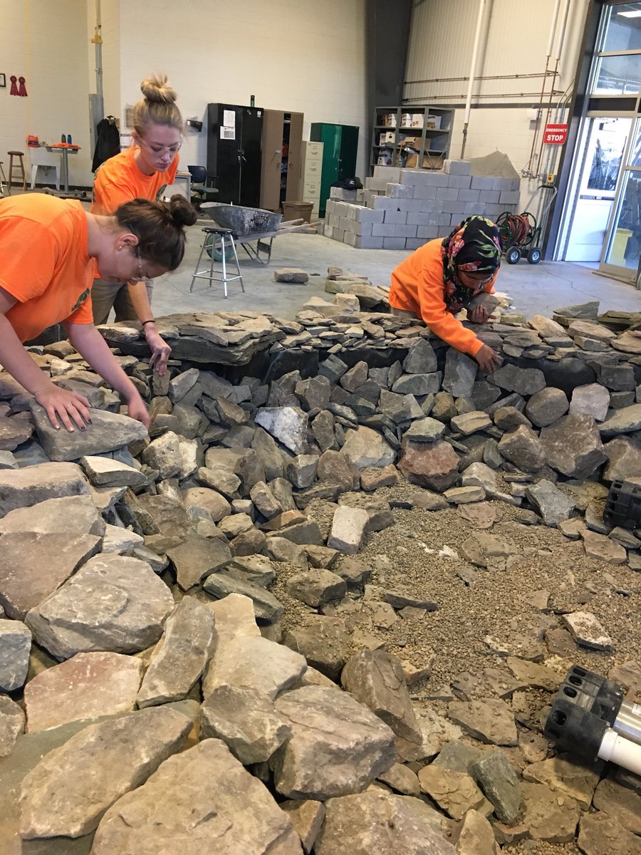 ETHSLandscape's tweet photo. Paying attention to detail as we put the finishing touches on our waterfall. #whatdidwedoinlandscapetoday https://t.co/Hlq0DqBePz