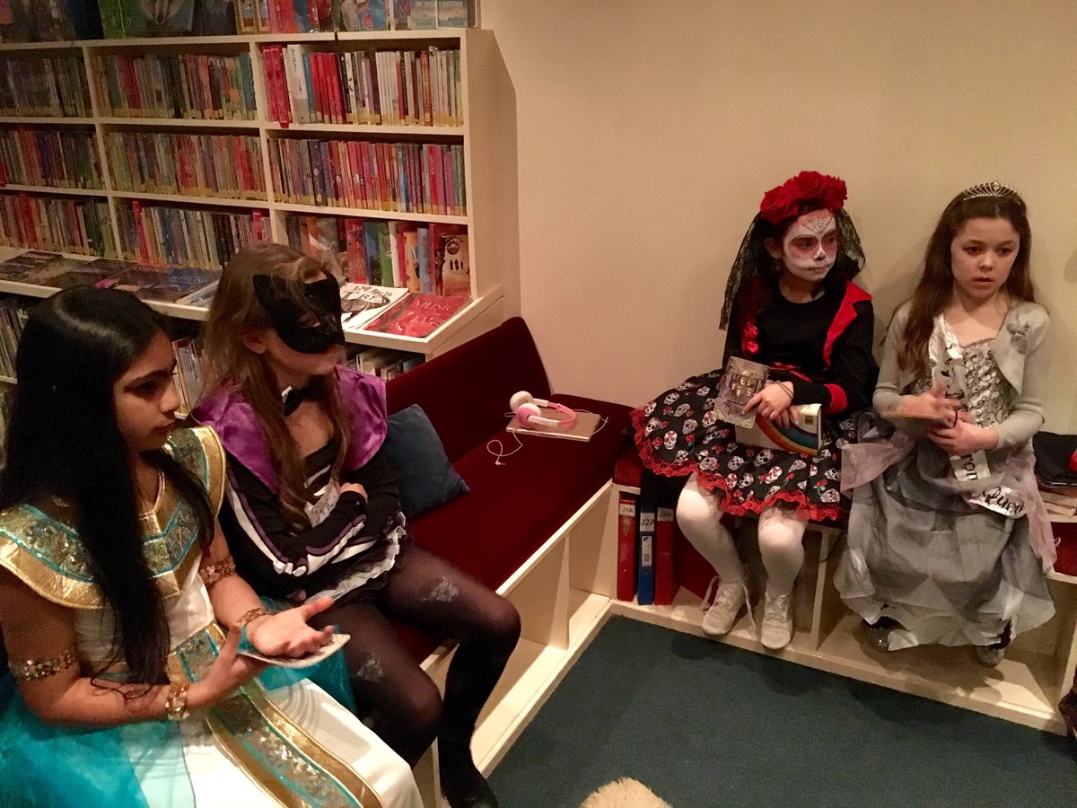 Kelvinside1878's tweet photo. At lunchtime the lights were turned down in the Junior Library and spooky stories and poems ensued. #KAJ3 & #KAJ5 found it spooktacular! https://t.co/xJeKHGKCe4