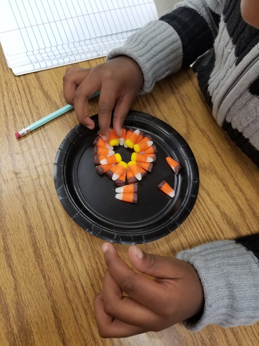 Ms. Lambert's First grade class used candy corn to make a circle and stack them.