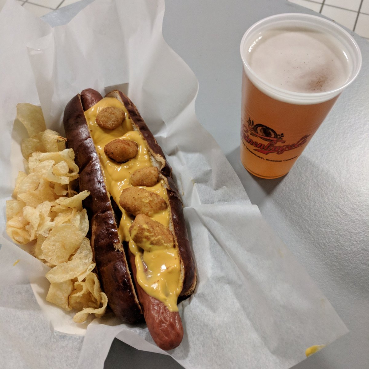 BradHornback's tweet photo. The Milwaukee Dog: a footlong hot dog soaked in Leinenkugel's with cheese sauce and cheese curds on a pretzel bun. #BucksVsThunder #NBAFood https://t.co/WLGMtqDGAW