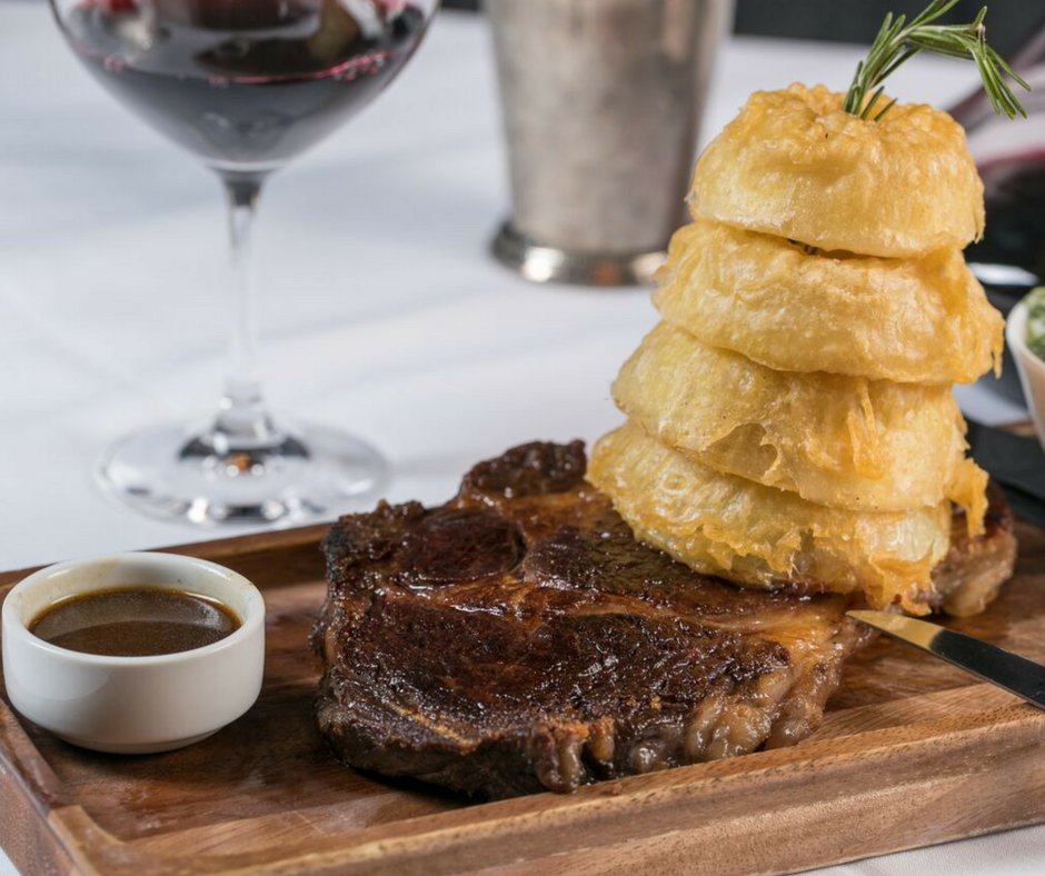 Creamed spinach, dry aged rib eye and some killer onion rings! Can't beat that combo!
