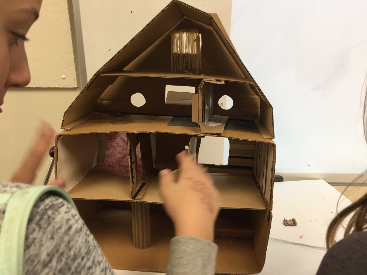 Fifth graders are making mini houses in art class.