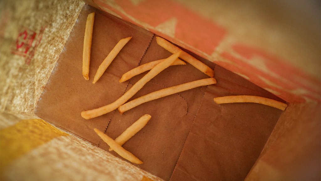 French Fries Falling Out Of Bag - Isolated Stock Photo, Picture and Royalty  Free Image. Image 94182315.