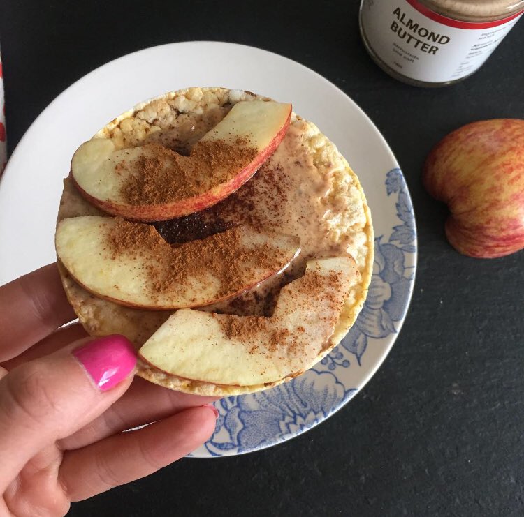 Snacking on a corn cake topped with Almond butter, sliced apple and cinnamon before heading over to @bootcamppilates #reformerpilates #snack