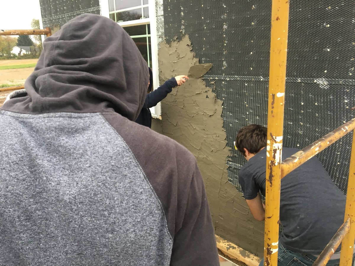 ken_v_olson's tweet photo. @PlymouthHSpcsc Building Trades students work on applying mortar for a brick wall and running electrical in the house. https://t.co/zCmKgRRd8A