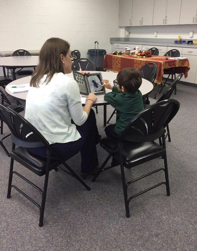 Dr. Tara Yerkes and technician Indigo Ware helping students with their vision screenings at the Holy Cross School in Dover!
