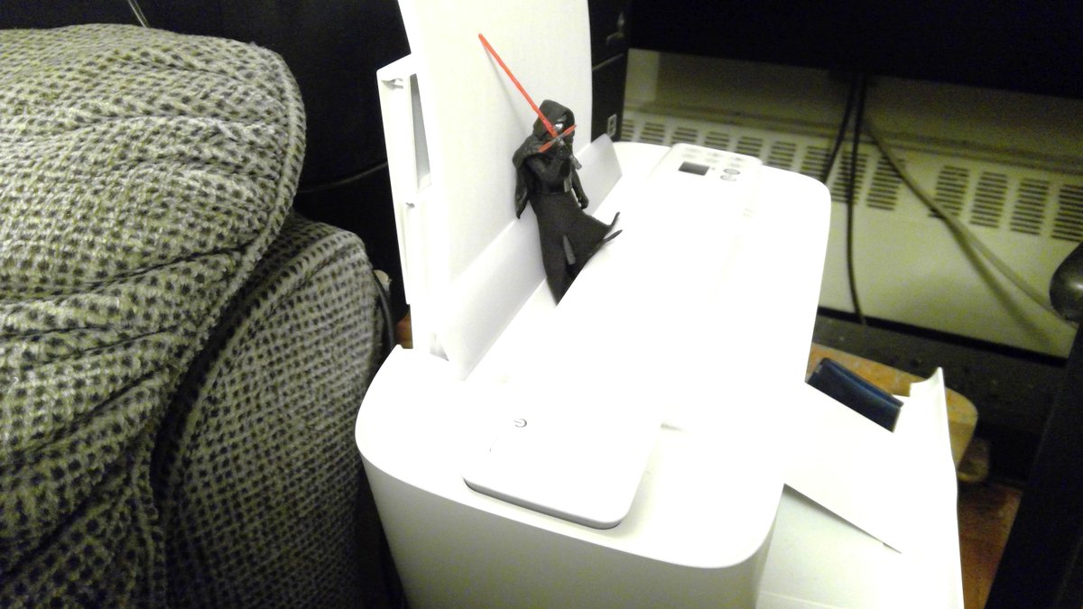 TinyKylo's tweet photo. "Halt, miscreant," says Tiny Kylo Ren.

He is good at guarding the printer.

No one wants to use it.

It is not even a very good printer. https://t.co/TbXo84E9gN