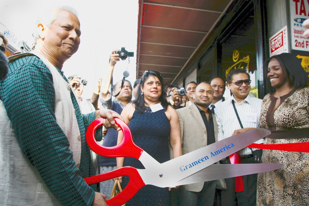 GrameenAmerica's tweet photo. #FlashbackFriday in 2008, Muhammad Yunus brought his Nobel award-winning microfinance model to the US &amp; we officially opened our first operations in Jackson Heights, Queens. Who doesn't love #GiantScissors? https://t.co/is2WOtYqHc