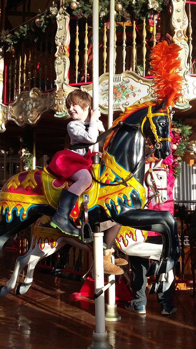 smaychel's tweet photo. The Christmas market opened today in town! Audrey managed to find the one black horse on the carousel 😂 #ProtoGoth https://t.co/vKIWFq1E9w