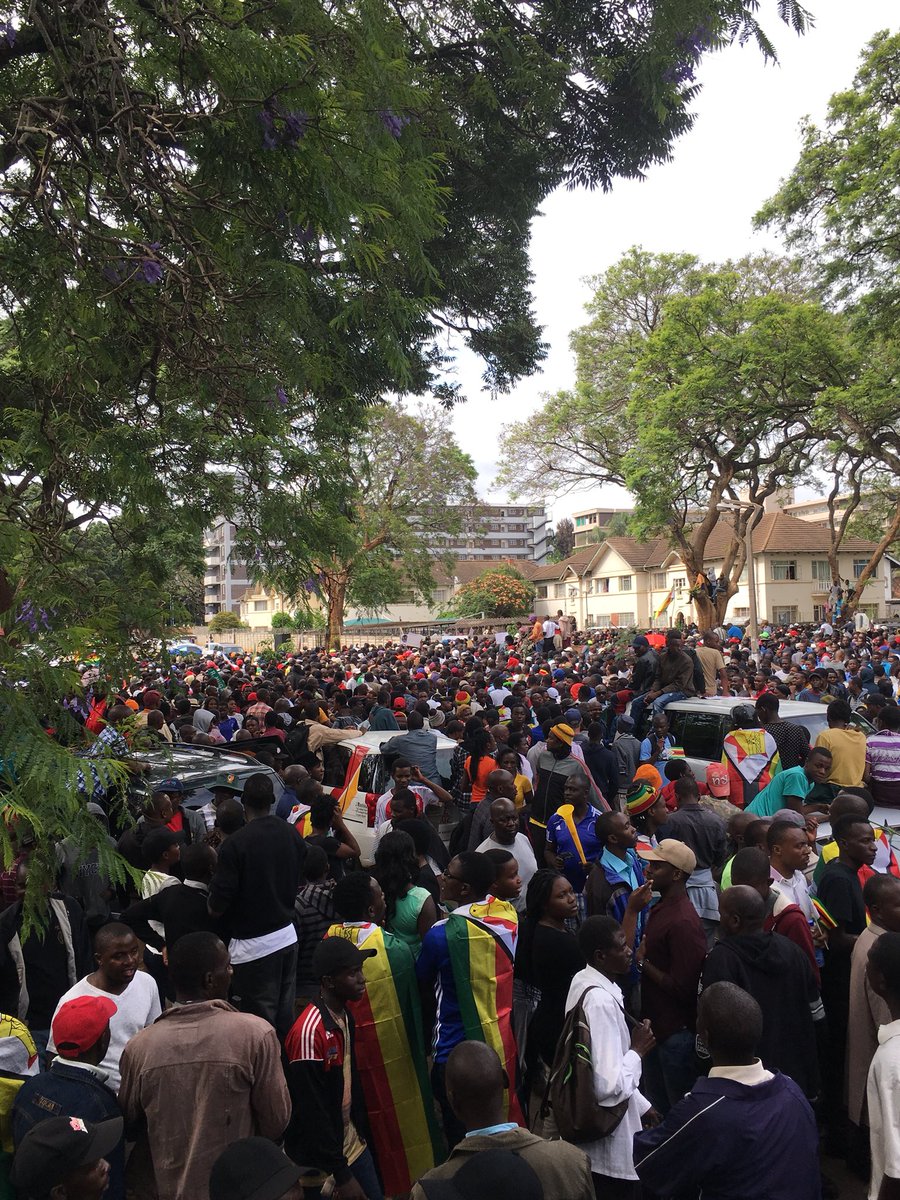 DougColtart's tweet photo. Marchers now camped outside State House. The military are blocking people from getting too close. People are desperate to see the back of Mugabe! #Zimbabwe #SolidariryMarch #MugabeMustGo https://t.co/X9jjY4Bcep