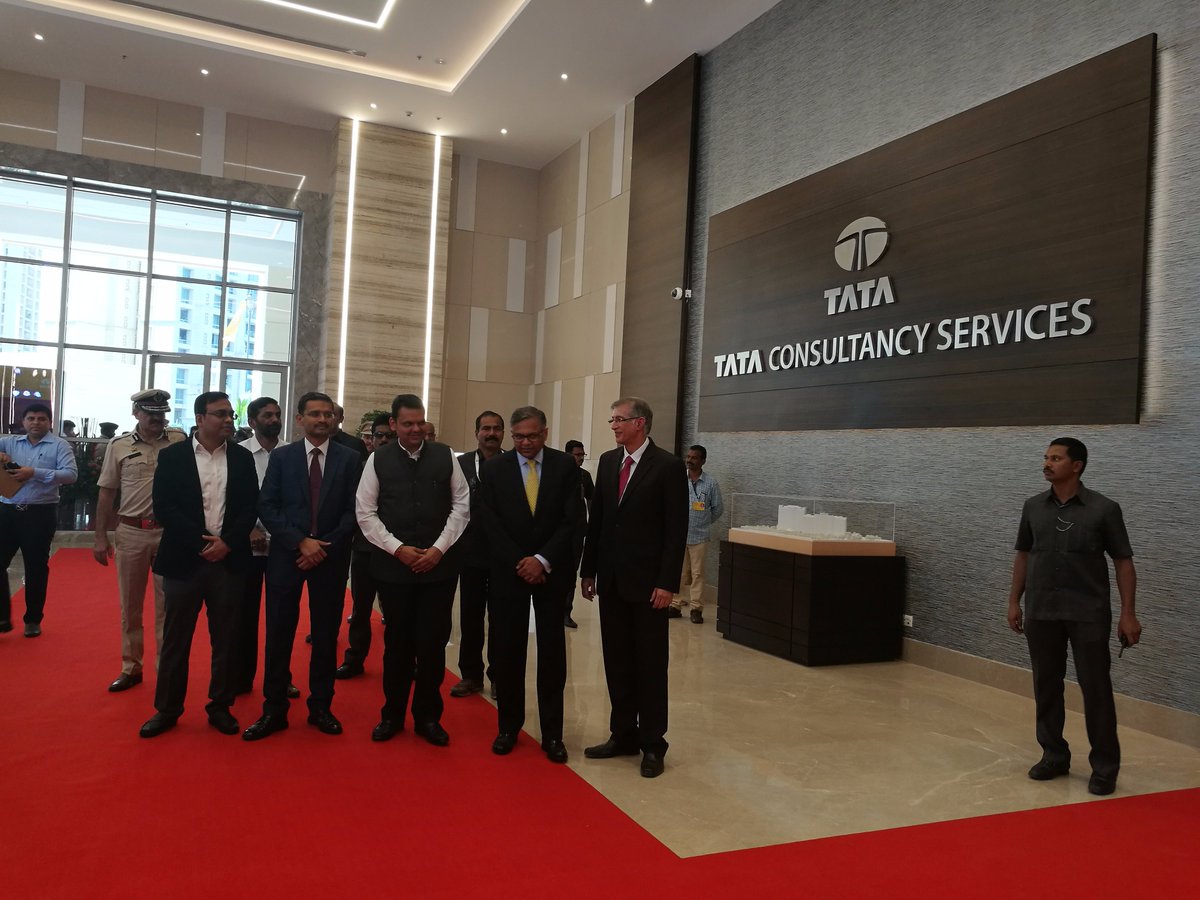 TCS's tweet photo. .@Dev_Fadnavis, the hon'ble CM of Maharashtra, inaugurated #TCSOlympus today. Pictured here is the CM along with CEO Rajesh Gopinathan and Tata Sons' Chairman N. Chandra and #TCSGlimpses of the new office. https://t.co/uGDYkjpV0p