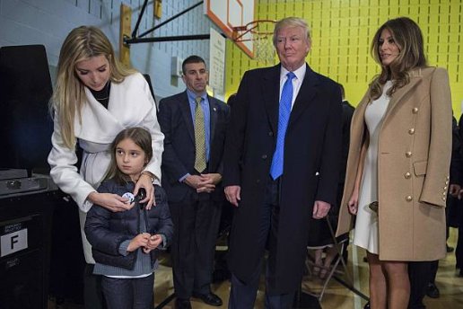 (16) A relaxed affair, as Ivanka Trump places a sticker on daughter Arabella while they wait for Jared Kushner to turn in his ballot paper.