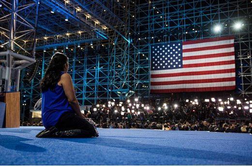 (51) This young woman who had been sitting in the seats at the back of the stage knelt there as the center was emptying out. Attention seeking? IDK. But most present there were unable to lose with dignity. No win no trophy.