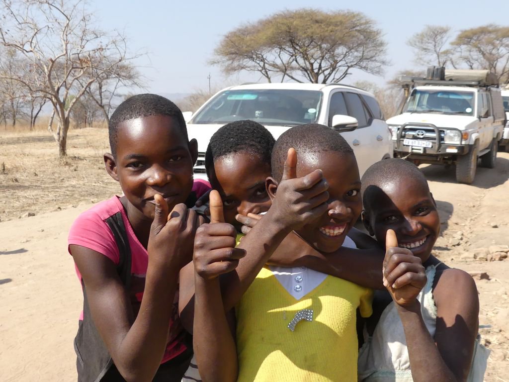 Flat tire on remote road to Kariba. Local "helpers" appear out of nowhere. #EpicZimbabweJourney <a href="/IFWTWA/">IFWTWA</a>