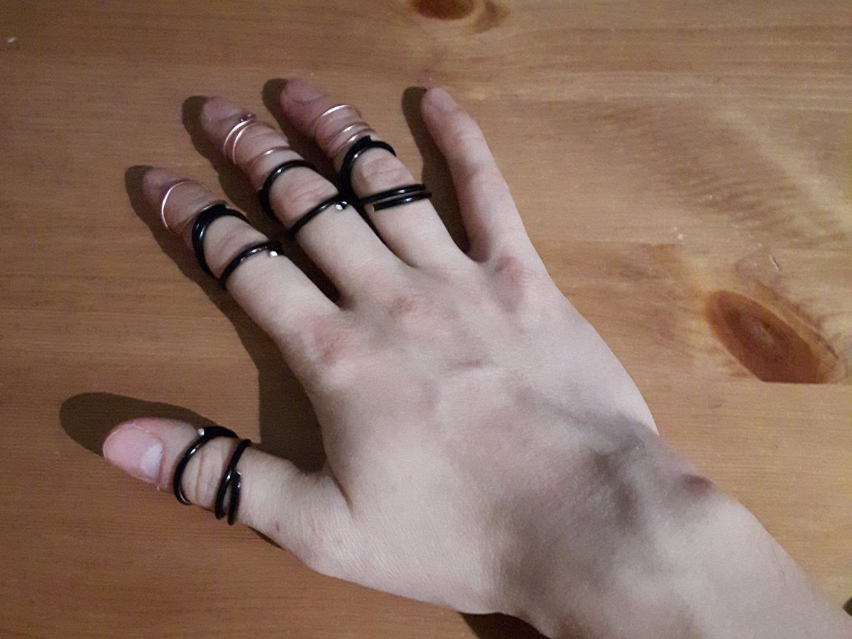 happynotafish's tweet photo. DIY ring splints aesthetic. #ringsplints #EhlersDanlosSyndrome 

[Image description: a hand laid on a table with ring splints in copper or black wire on three fingers and the thumb.] https://t.co/7AsTuKrXYi