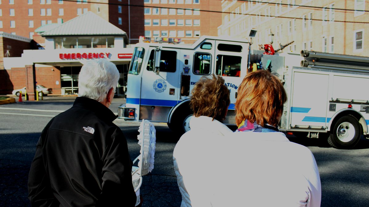 Family members of <a href="/PAStatePolice/">PA State Police</a> trooper Cpl. Seth Kelly watch as a procession of first responders drive by St. Luke's Fountain Hill on Sunday, Nov. 12, 2017.