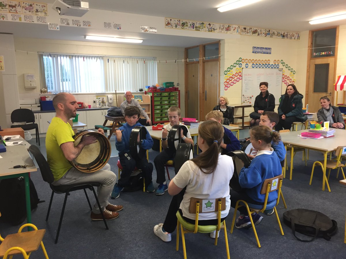 StPatricksNS's tweet photo. St Patrick's NS was delighted to welcome the National Director, Board members and staff of Music Generation to our school on 9th November.  All were delighted to join a lively bodhrán workshop with tutor Robbie Walsh &amp; his class! https://t.co/snsjmrqpNE
