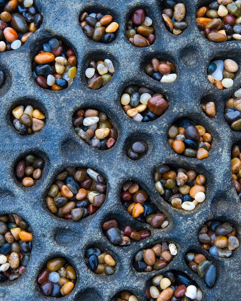 Tafoni pockets are a common sight along the California Coast, but on Pebble Beach they were filled with incredible colorful, bean-sized stones - true "Jewels of the Ocean".

Visit Amazing Geologist for more..