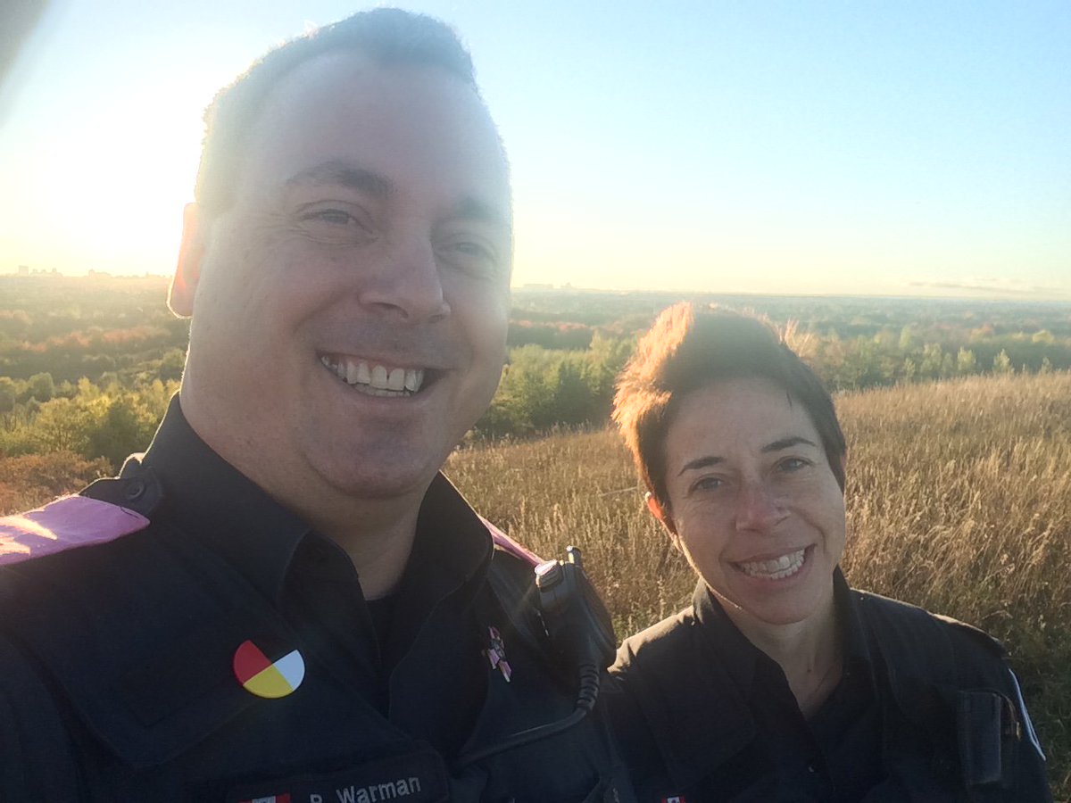 TPSGuardian's tweet image. Good Afternoon all... I just came across this photo of PC Stone and I from last fall.  I keep forgetting that even in the center of this dense metropolis we call Toronto, there are some beautiful vistas...can anyone guess where this is?