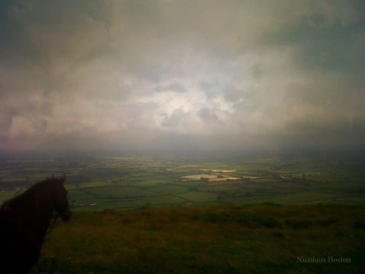 View from Knockfierna, County Limerick.
Thou rising sun, how richly gleams,
Thy smile from far Knockfierna's mountain,
O'er waving woods and bounding streams,
And many a grove and glancing fountain.'