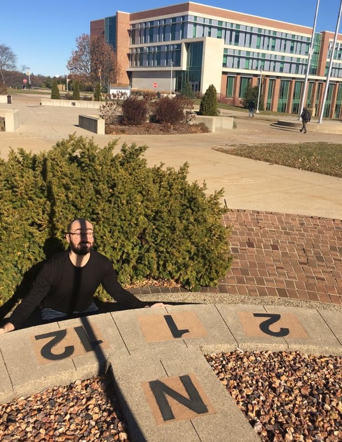 tweetsauce's tweet photo. I found an awesome sundial @WesternMichU 🌞 This photo was taken at exactly 12:00pm EST. The sundial is running fast because of Earth's tilted axis. To correct for this, the equation of time plaque advises subtracting ~12 minutes from what the shadow says. https://t.co/X1jLHym5hO
