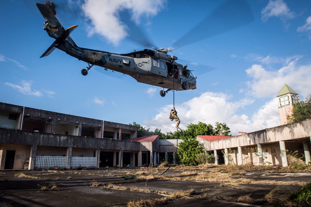 Courtesy of a @USNavy #MH60S #Seahawk w/ Helicopter Sea Combat Squadron 25, this #Sailor w/ #EOD Mobile Unit 5 fast-ropes into an abandoned mall during an insertion & hostage rescue exercise in Saipan, Northern Mariana Islands @USPacificFleet #EODMU5 #HSC25 #IslandKnights #USNavy