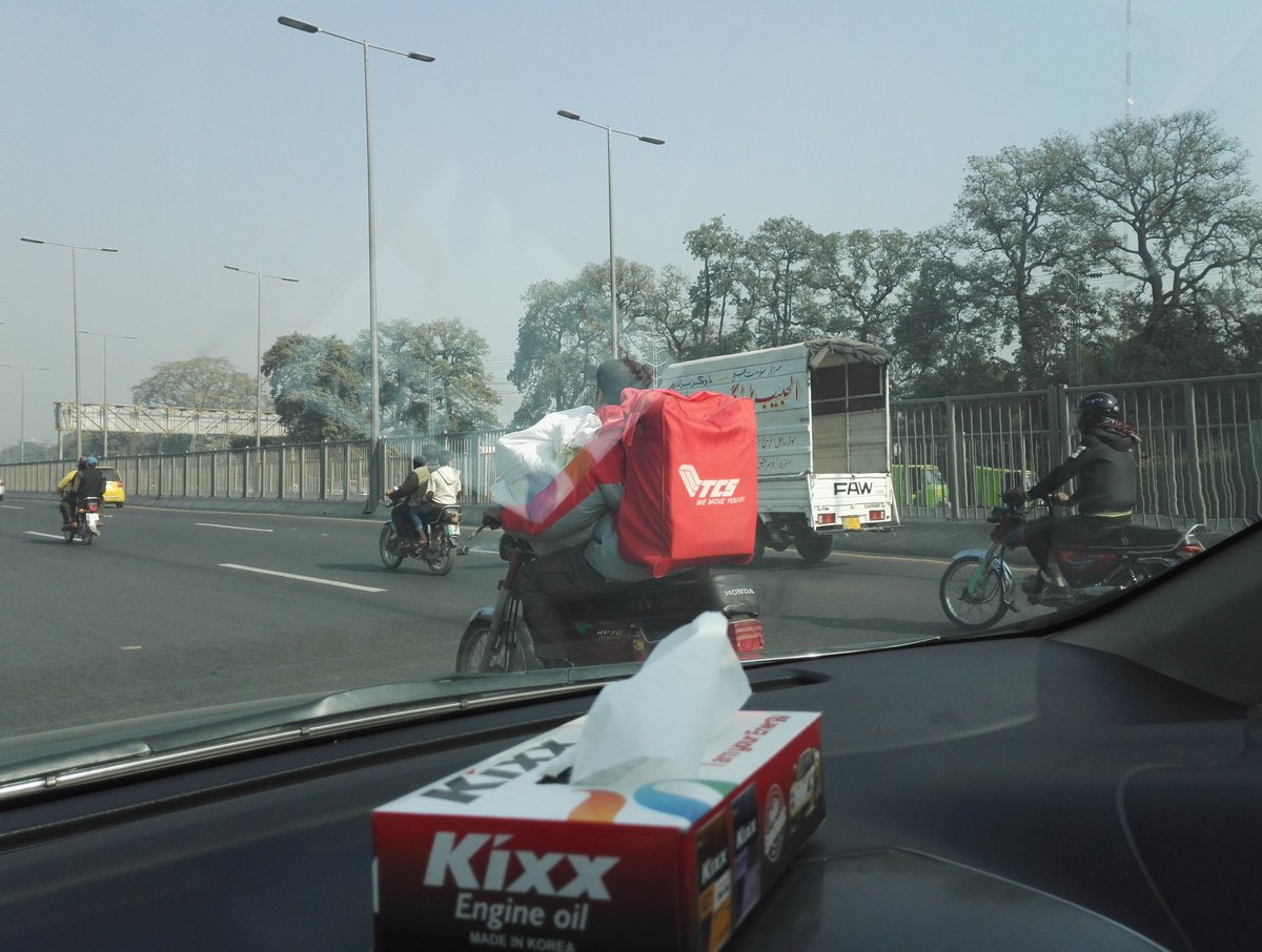ZeeshZaf's tweet photo. @adeel_azhar spotted in lahore. I think TCS should give some consideration to rider safety... really dangerous way to transport larger packets .. https://t.co/yCgjomV7kE