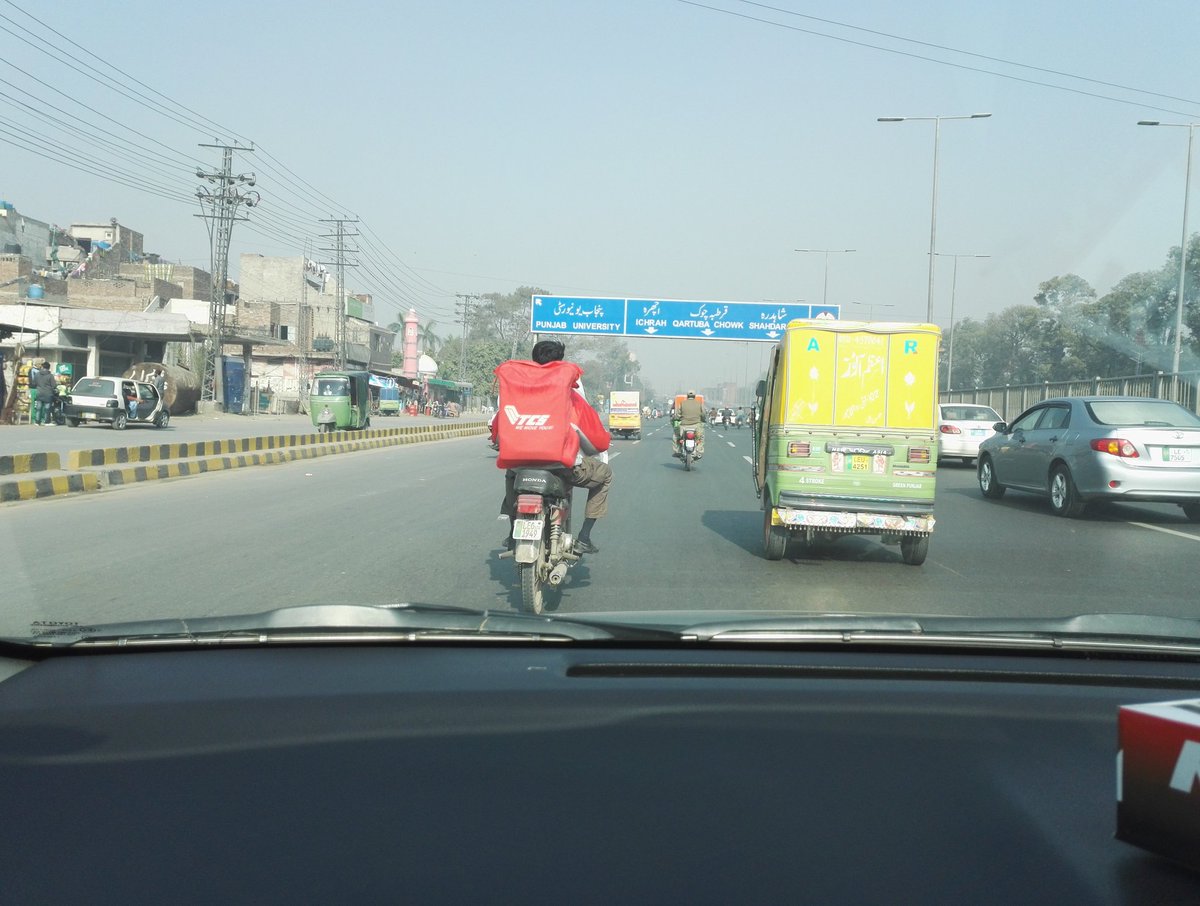ZeeshZaf's tweet photo. @adeel_azhar spotted in lahore. I think TCS should give some consideration to rider safety... really dangerous way to transport larger packets .. https://t.co/yCgjomV7kE