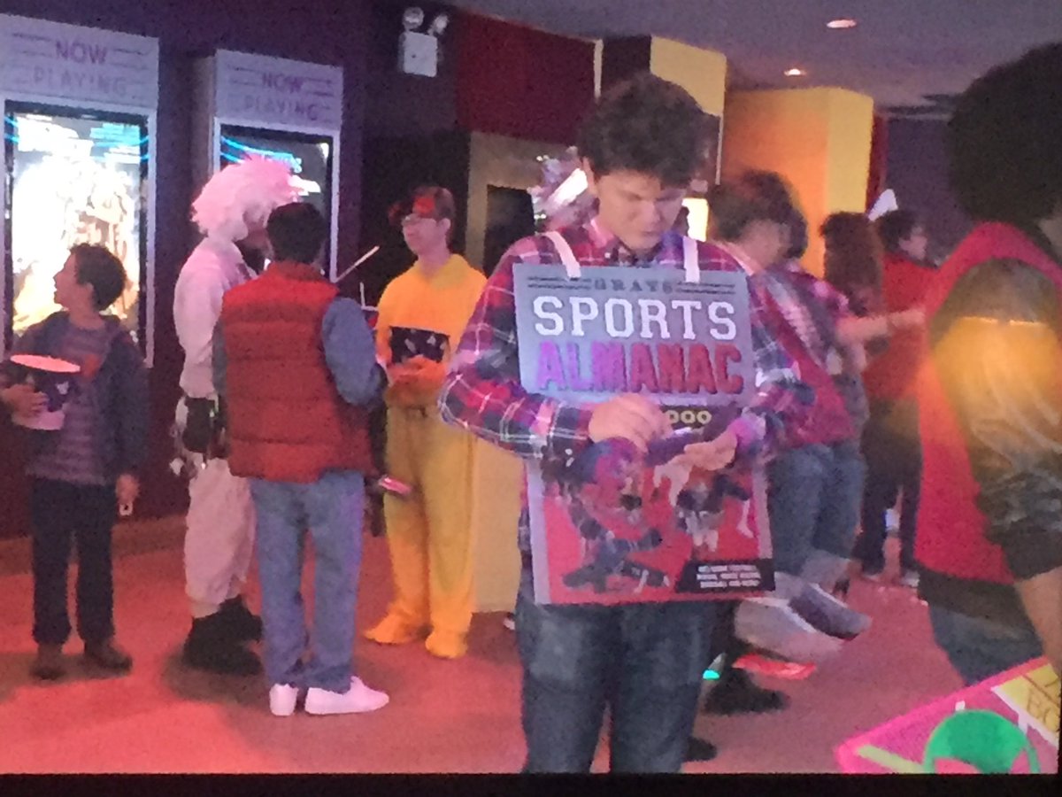 Kocchatollah's tweet photo. Gray’s Sports Almanac sandwich board guy is the best BTTF cosplay https://t.co/BFs2dsMknd