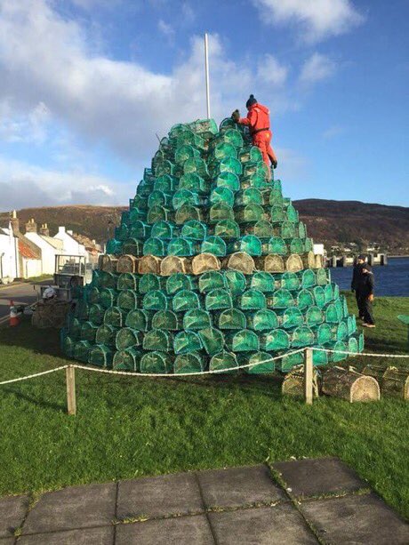 jk_rowling's tweet image. How beautiful is this? Ullapool, a coastal town in Scotland, has a Christmas tree made of creels, with a crab on top.