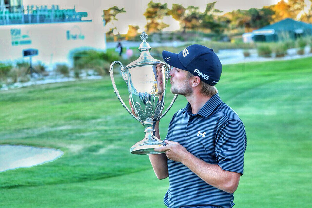 PGATour's tweet photo. First kiss for the first trophy. 😘🏆 https://t.co/0qNyhsi9Jm