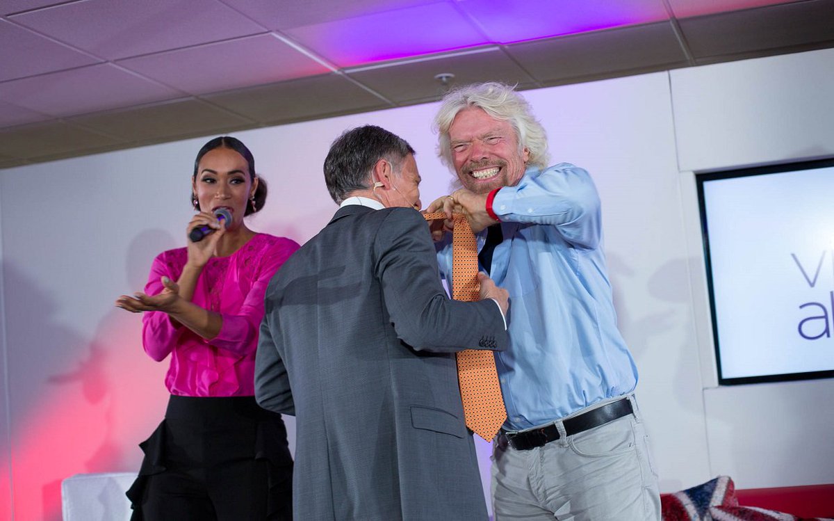 Virgin's tweet photo. Why did @richardbranson snip off Adrian Gore’s tie on stage? https://t.co/M1zfuBSOUR #TakeOffForSuccess @VirginAtlantic https://t.co/gZCkVBUPJd