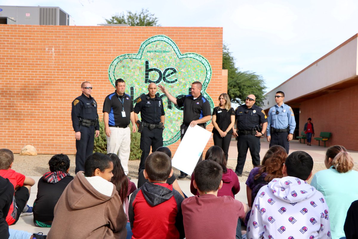 Tucson_Police's tweet photo. This morning, @TucsonCops presented @amphifoundation with a check from funds raised through a GoFundMe page. Amphi Middle School’s library was damaged in late Oct from vandalism and fire. More info here: https://t.co/2WcTto1s8z https://t.co/prrD2Vg01x