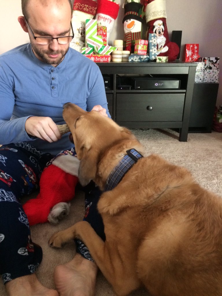 KimmieAM's tweet photo. @Shopkick A15: Here is my hubby helping our dog open his stocking last year!  💕#HolidayShopKicking #Sweepstakes https://t.co/Yx1WcGJJWN