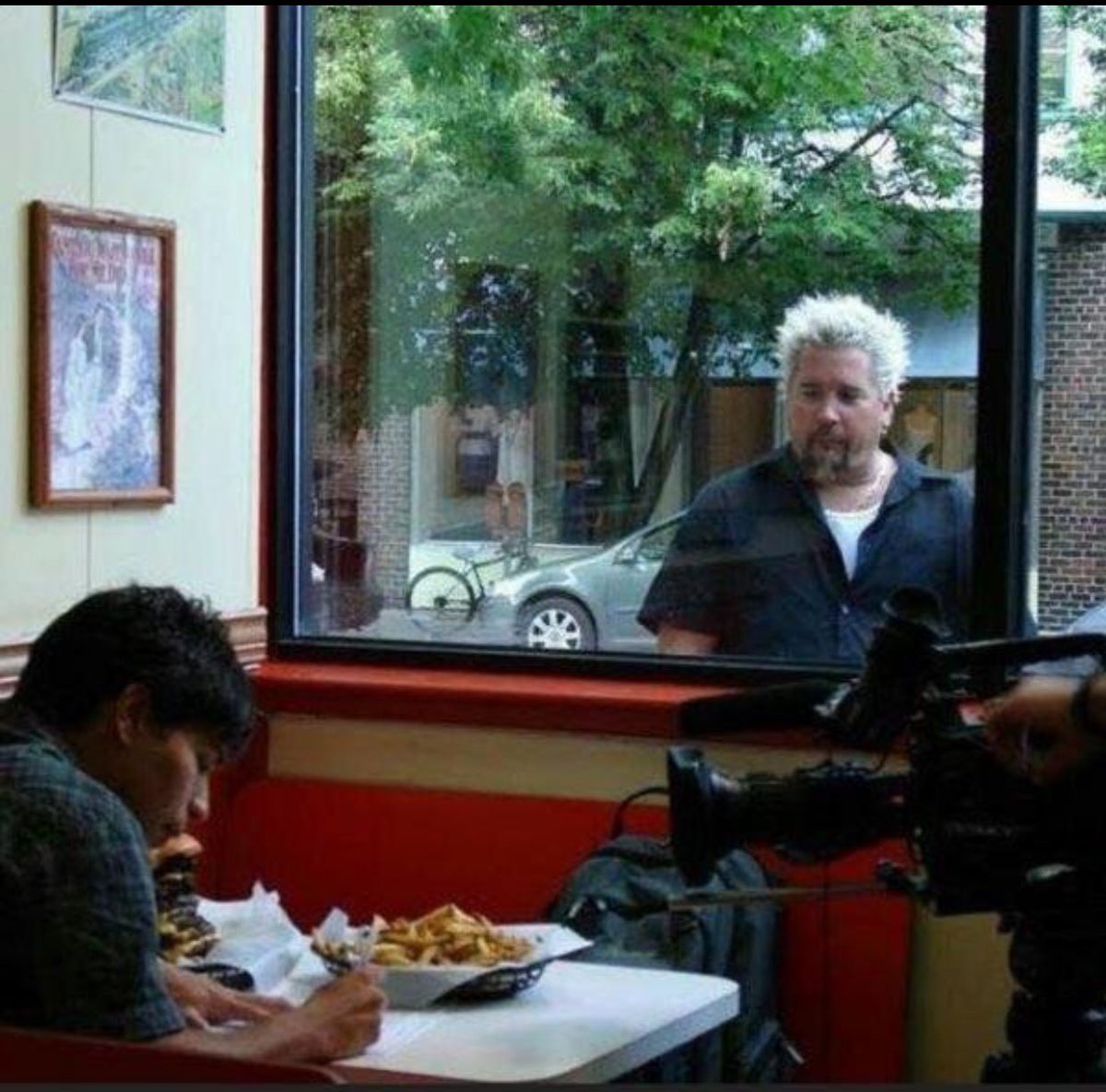 Homeless man after the Stock Market crash of 1929 longingly looks at a strangers food (1930; Colorized)