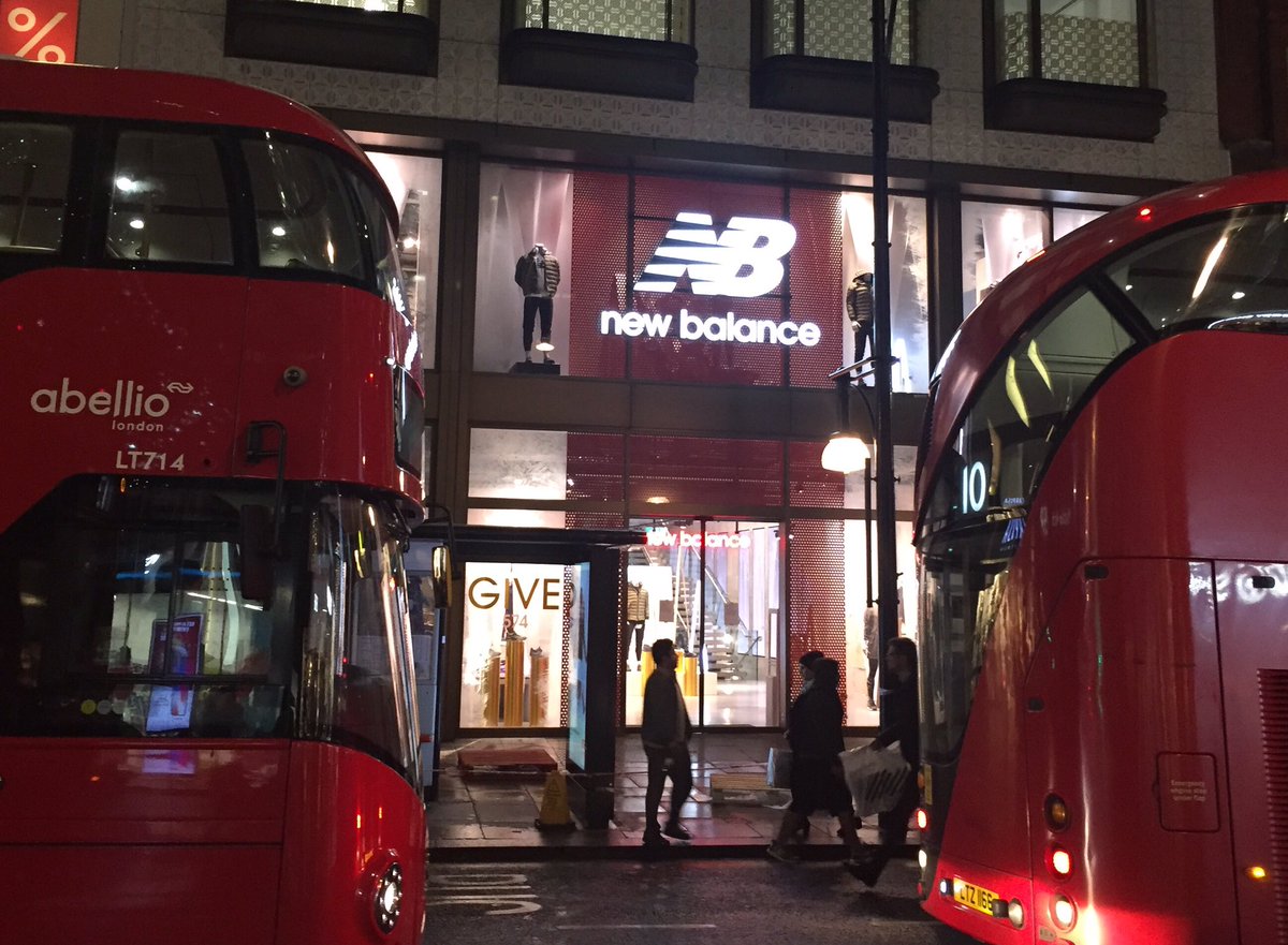 MichOConnell's tweet photo. It's always a delight to see our customers doing well when traveling. Here's @newbalance in-between two double-decker buses on Oxford St in London. Christmas shopping starting up. Get some shoes! @TIBCO #Spotfire. https://t.co/OgdojFpYkG
