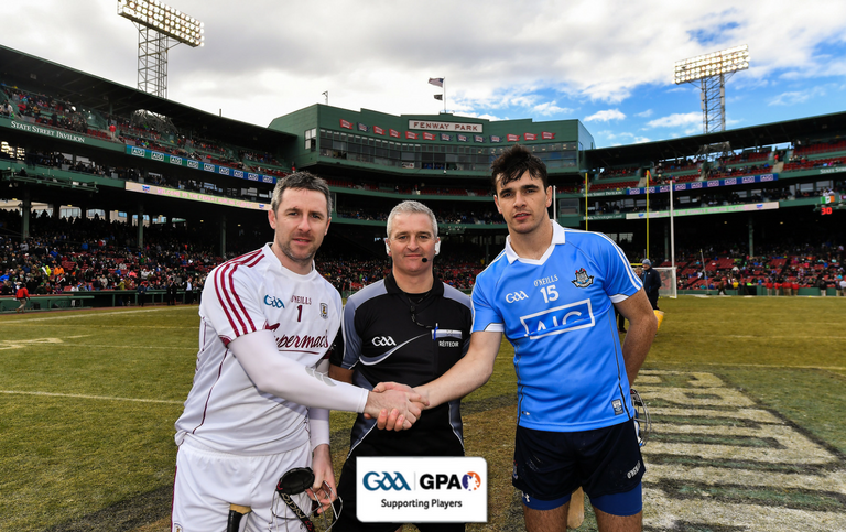 Team captains Colm Callanan &amp; Danny Sutcliffe with referee Johnny Ryan before the AIG Super 11's Fenway Classic Semi-Final match between Dublin and Galway. #AIGFenwayHurling