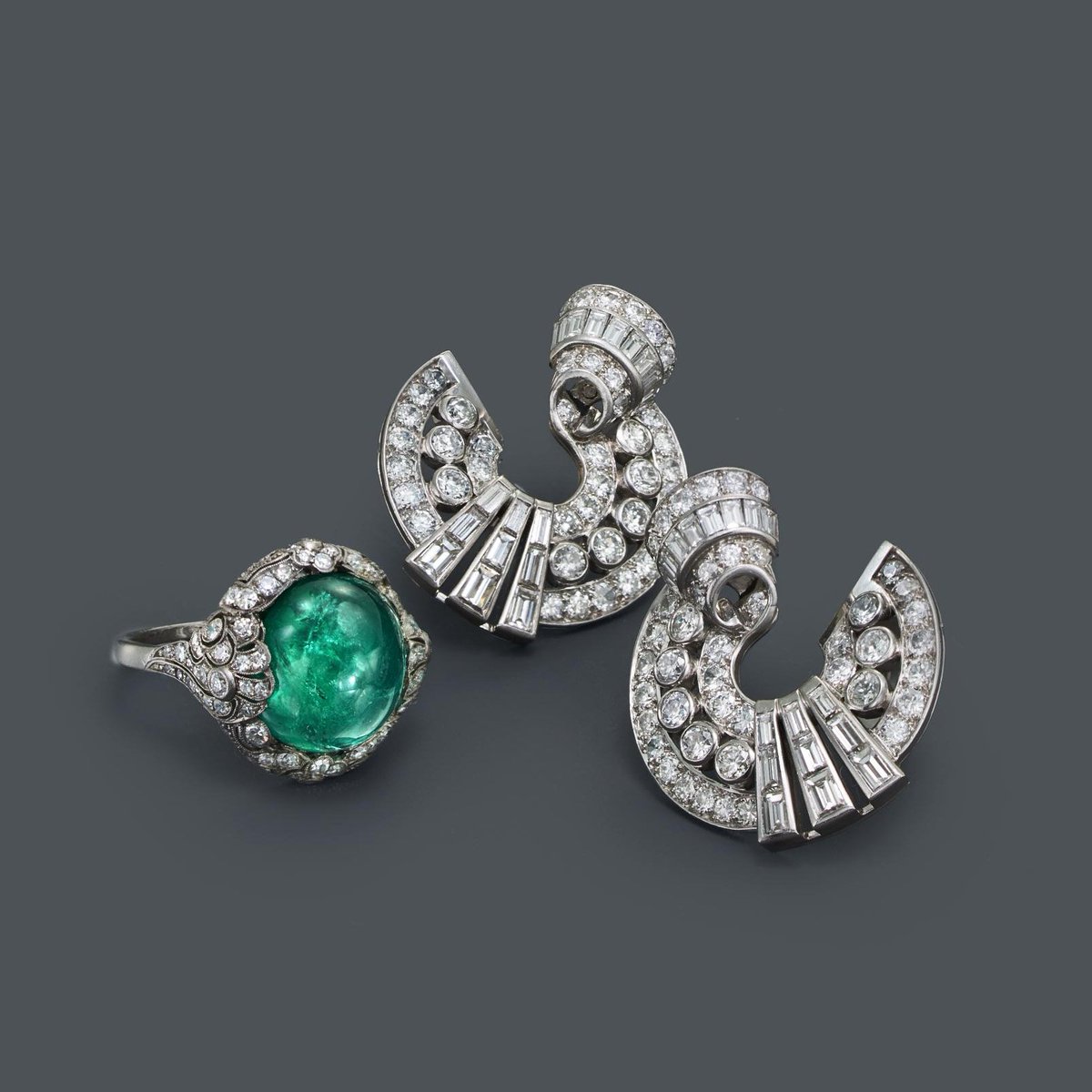 Defined by geometric shapes and bold color schemes, designs of the Art Deco period reflect the playful attitudes of the era. A cabochon emerald and diamond floral motif ring and diamond earrings. #ArtDeco #FredLeighton