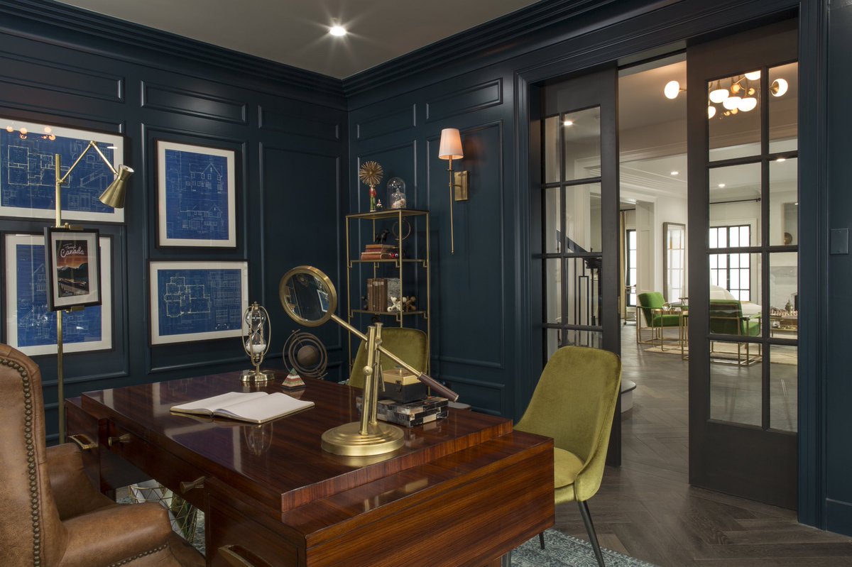 Deep blue painted and paneled den with pocket doors
