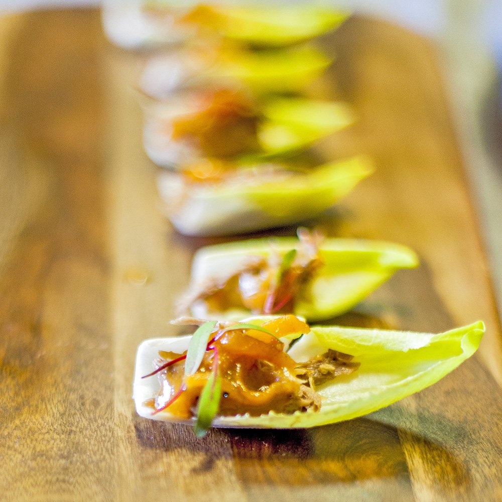Endive Spear with Duck Confit and a Spiced Persimmon Glaze garnished with Pickled Onion #events #boutiquecatering #buffet #weddings #parties #meetings #eventdesign #cateringlife #cateringservices #culinaryart #culinarylife #foodography #foodgenius #sfcatering #bayarea #sfbayarea