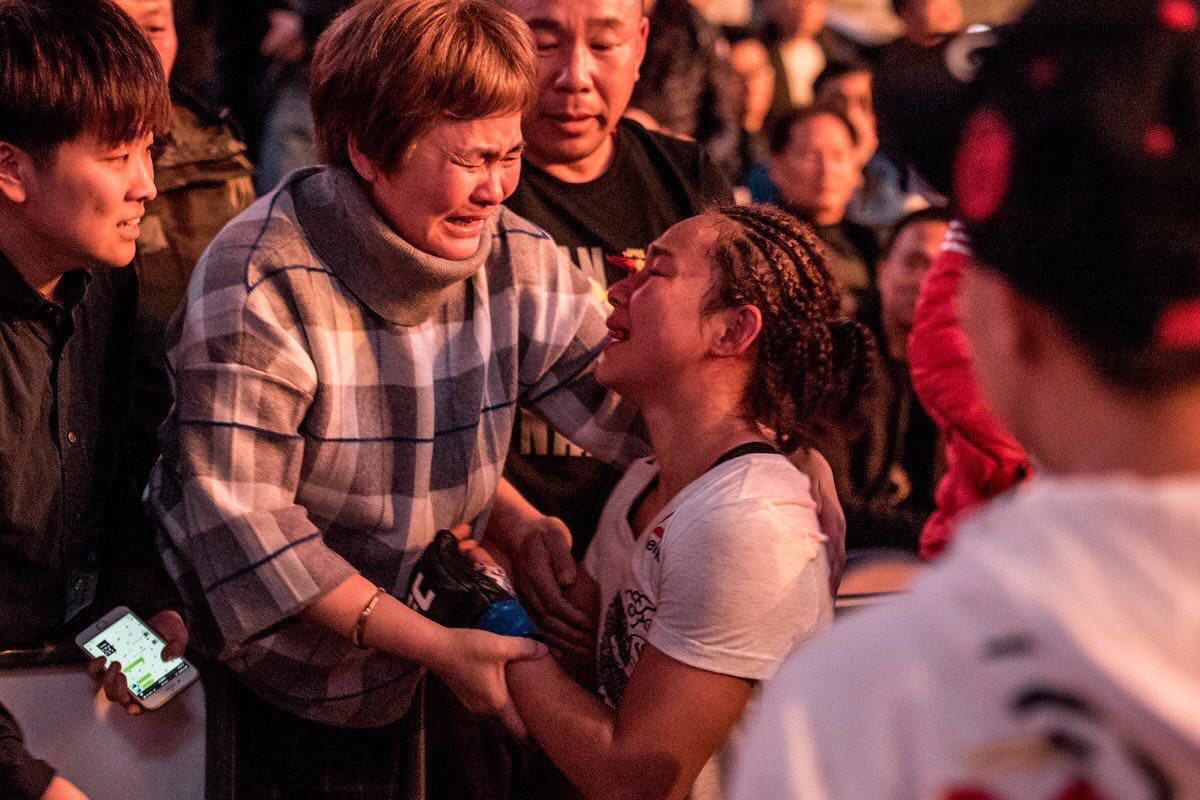 ChinaSports's tweet photo. #UFCShanghai A night of great fights in the #UFC ’s maiden event in mainland China. The fourth consecutive win from Li Jingliang and a successful debut from Wang Guan get the crowd cheering nonstop. #PhotoOfTheNight Parents of Yan Xiaonan get extremely emotional after her win. https://t.co/xTNQ2e6LcF